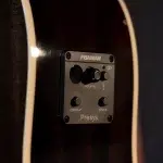 Close-up of a Fishman Presys preamp panel embedded in an acoustic guitar, showing the volume knob and contour/phase controls on the faceplate. ขายราคาพิเศษ