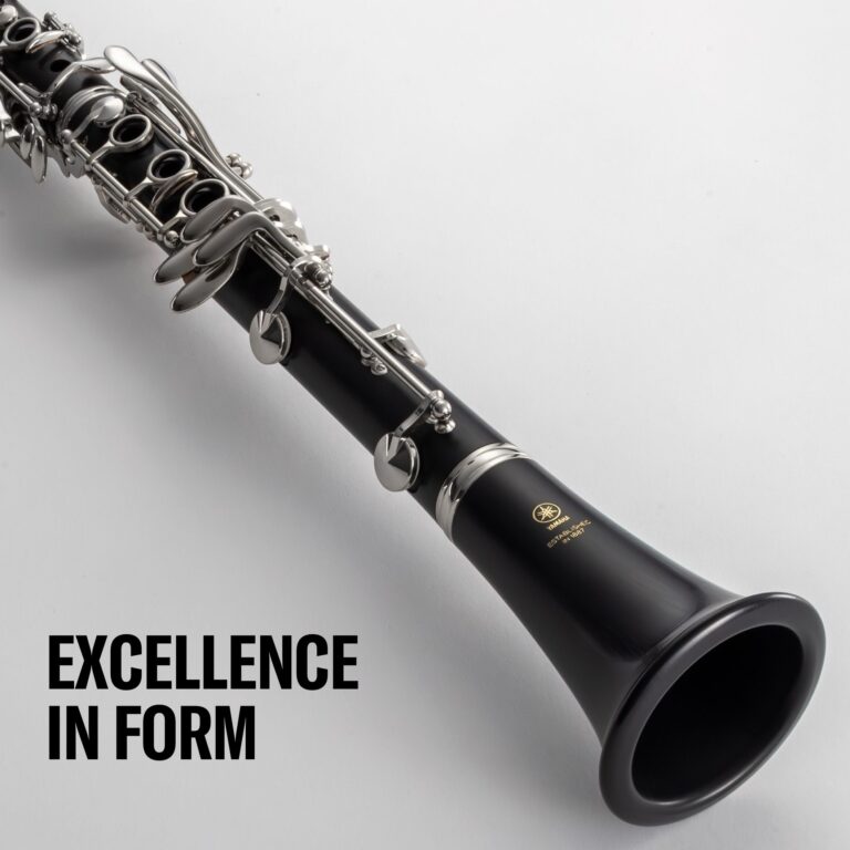 Close-up of a black and silver clarinet showing keys and tone holes, with partial text reading 'EXCELLENCE IN FORM' at the bottom. ขายราคาพิเศษ