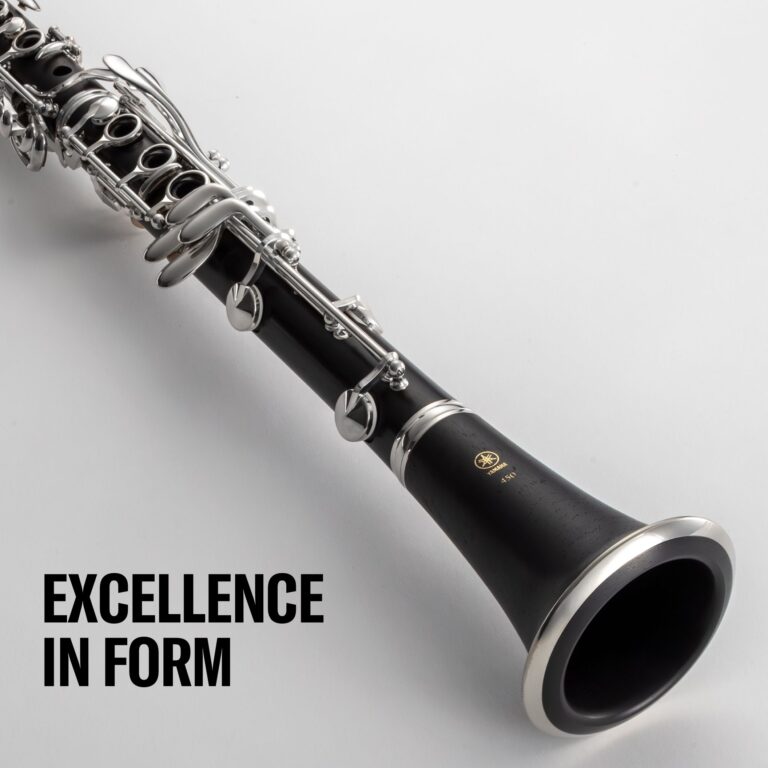 Close-up of a black clarinet with shiny silver keys, angled across a light background, with bold text 'EXCELLENCE IN FORM' at the bottom left (partial). ขายราคาพิเศษ