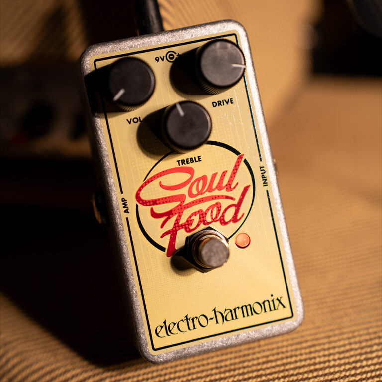Close-up of an Electro-Harmonix Soul Food guitar pedal with four knobs (Vol, Drive, Treble, Amp) and a footswitch on a beige surface. ขายราคาพิเศษ