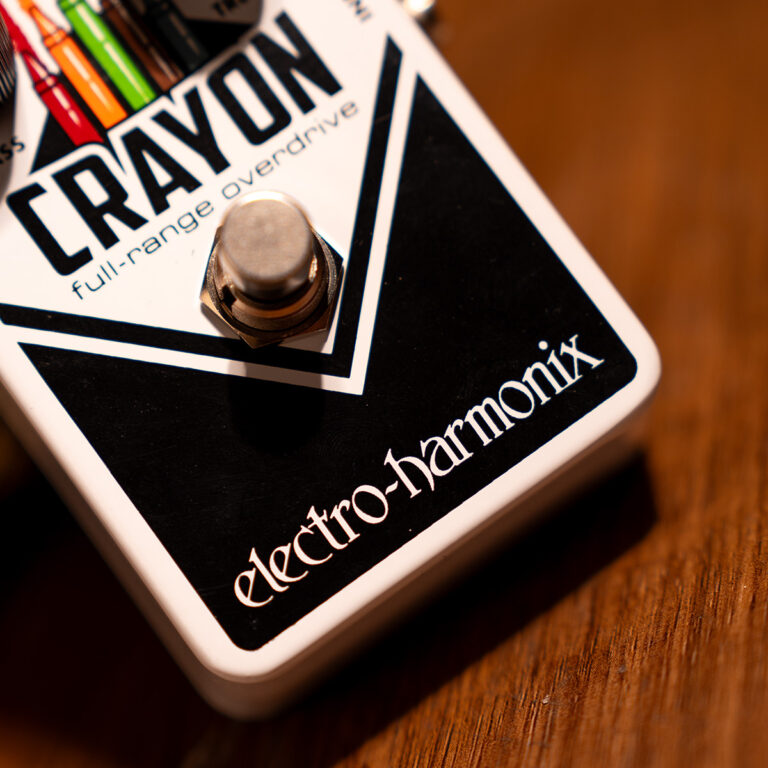 Close-up of an Electro-Harmonix Crayon overdrive guitar effects pedal with a metal footswitch and colorful knobs visible. ขายราคาพิเศษ
