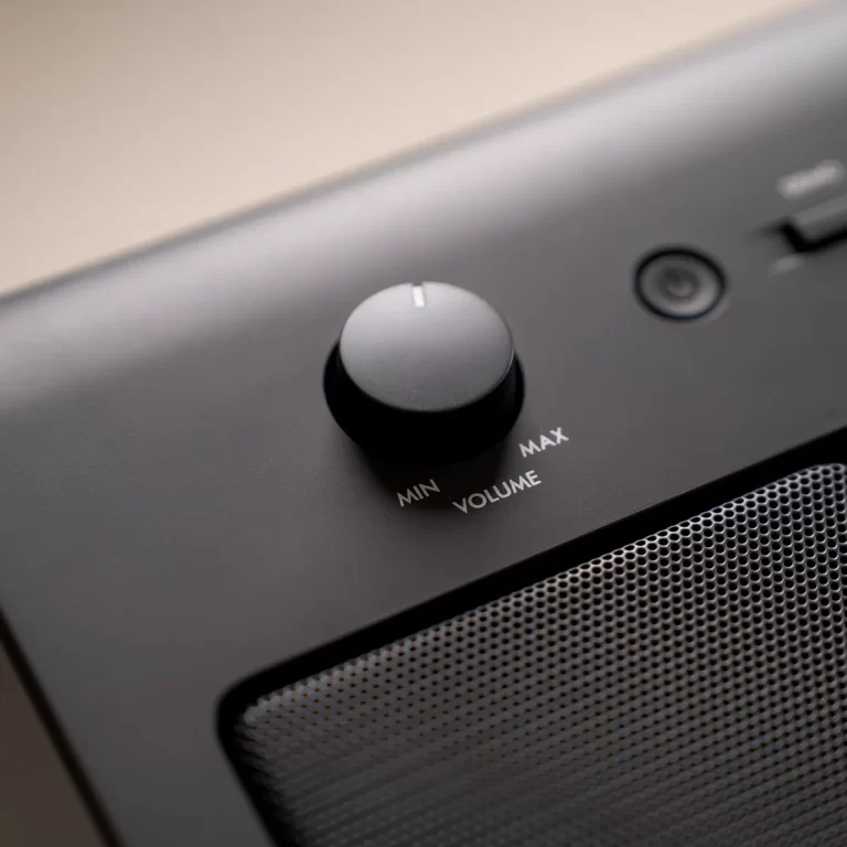 Close-up of a round volume knob on a speaker panel labeled MIN and MAX. ขายราคาพิเศษ