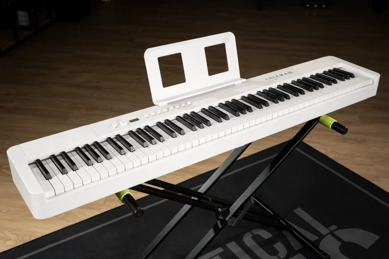 White electronic keyboard on a black stand with a white music stand in front, placed on a wooden floor. ขายราคาพิเศษ