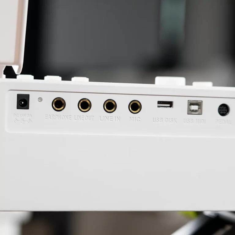 Close-up of a white device's panel showing jacks labeled Earphone, Line Out, Line In, Mic, USB Disk, USB MIDI, and Pedal on a white surface. ขายราคาพิเศษ