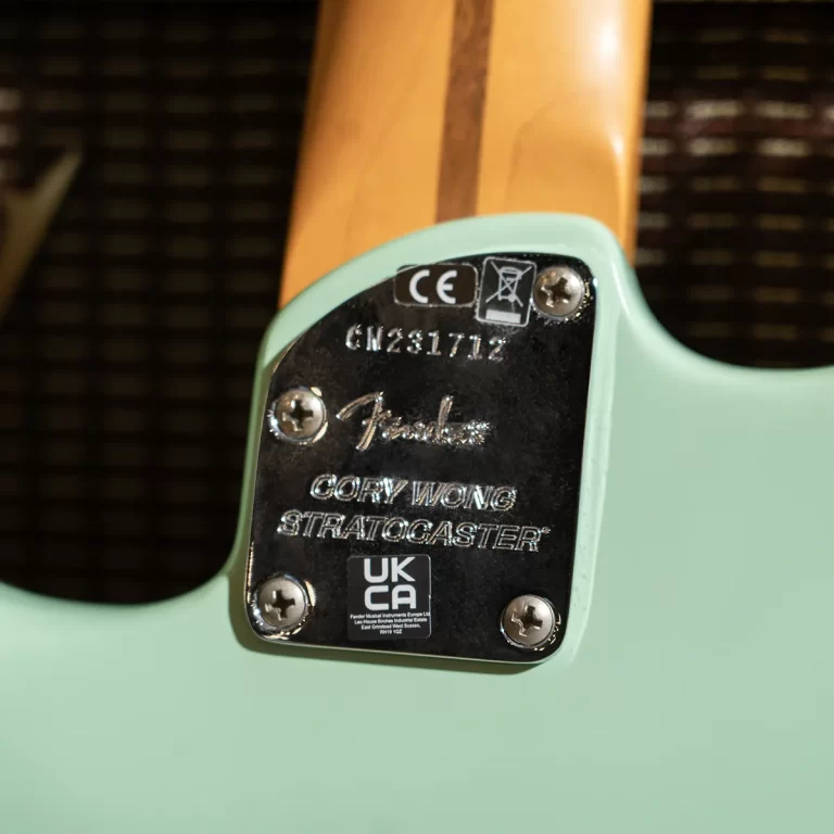 Back plate of a sea-green Fender Stratocaster guitar with a maple neck; shows Fender logo, serial CN231717, and 'COPY WONG STRATOCASTER' text. ขายราคาพิเศษ