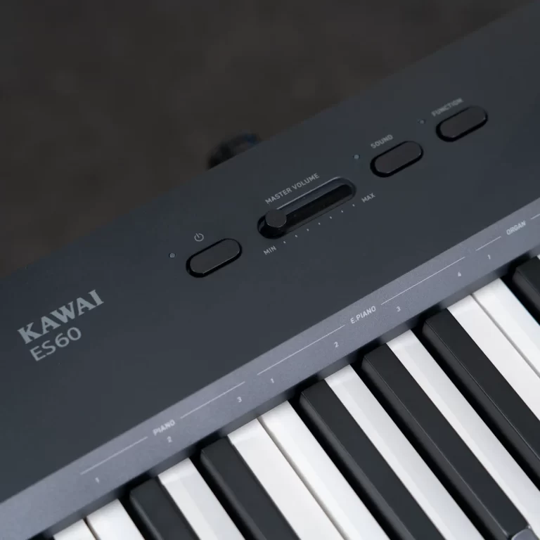 Close-up of a KAWAI ES60 digital piano top panel with the master volume slider and control buttons above the keys ขายราคาพิเศษ