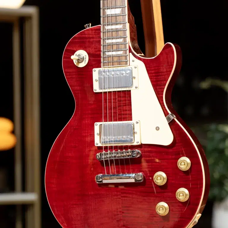 Red electric guitar with cream pickguard, gold knobs, and chrome hardware close-up on a deep finish. ขายราคาพิเศษ