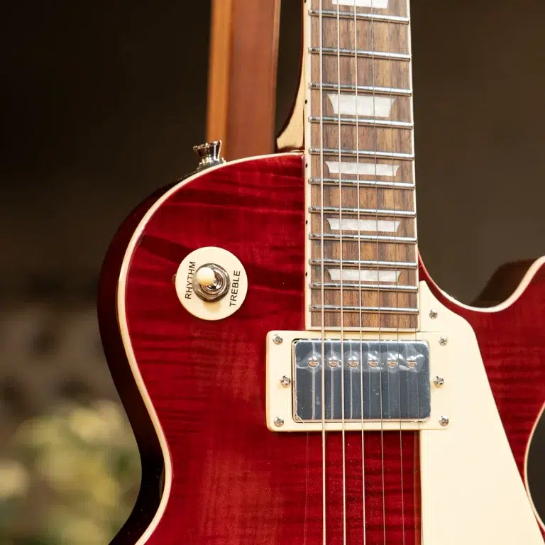 Close-up of a red electric guitar body showing the neck, frets, strings, and a cream pickup with rhythm/treble control knob. ขายราคาพิเศษ