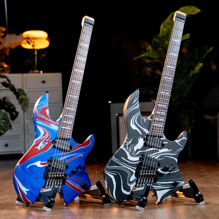 Two electric guitars with swirl-marble finishes on stands, set on a wooden stage against a dark background. ขายราคาพิเศษ