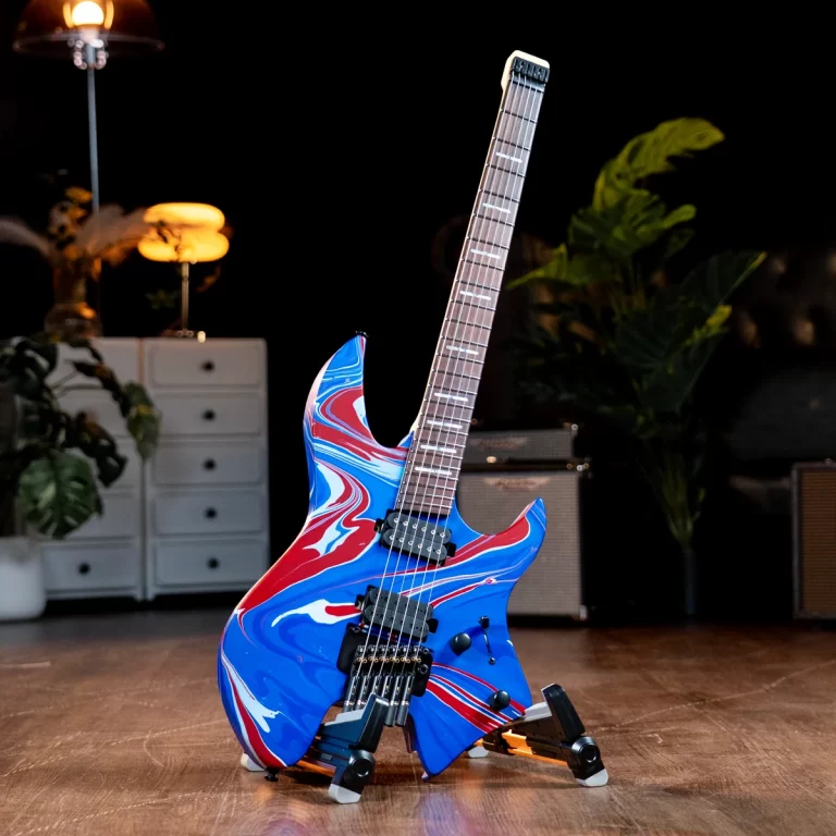 Electric guitar with a blue, red, and white marbled finish on a stand in a dark stage-like setting with amps in the background. ขายราคาพิเศษ