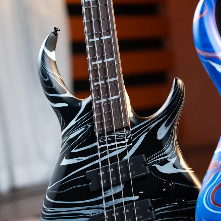 Electric guitar with a black-and-white marble finish and dual pickups, shown close-up on the body and neck. ขายราคาพิเศษ