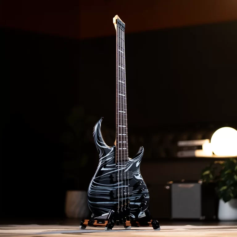 Electric solid-body guitar with a black and white marble pattern on a stand in a dim room on a wooden floor ขายราคาพิเศษ