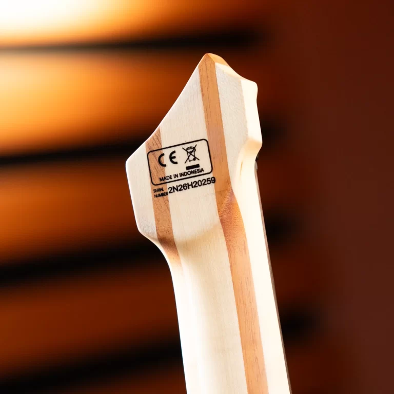 Close-up of a guitar neck heel with a CE mark and serial number, made in Indonesia. ขายราคาพิเศษ