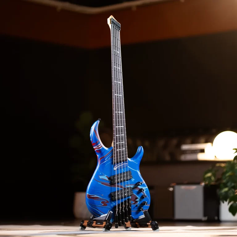Blue electric guitar with a marbled finish on a stand in a dim showroom. Descriptive of the guitar and setting. ขายราคาพิเศษ