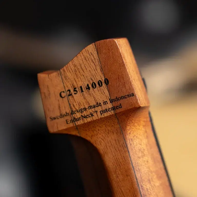 Close-up of a wooden piece with the model/serial text C2514000 and a Swedish design claim carved into the grain. ขายราคาพิเศษ