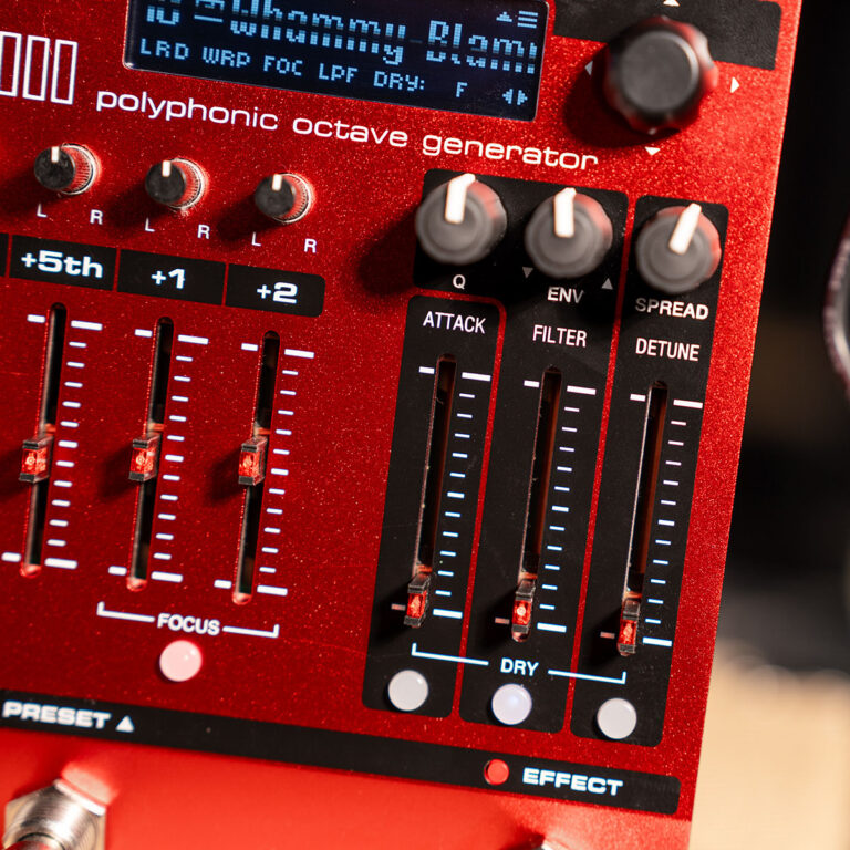 Close-up of a red polyphonic octave generator panel with knobs and vertical faders (Attack, Filter, Detune) and a small display above.”, ขายราคาพิเศษ
