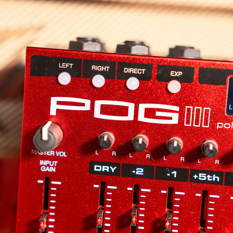 Red guitar effects pedal with black labels (LEFT, RIGHT, DIRECT, EXP) and multiple knobs and sliders on a wood surface surface behind it, showing 'POG' branding. ขายราคาพิเศษ