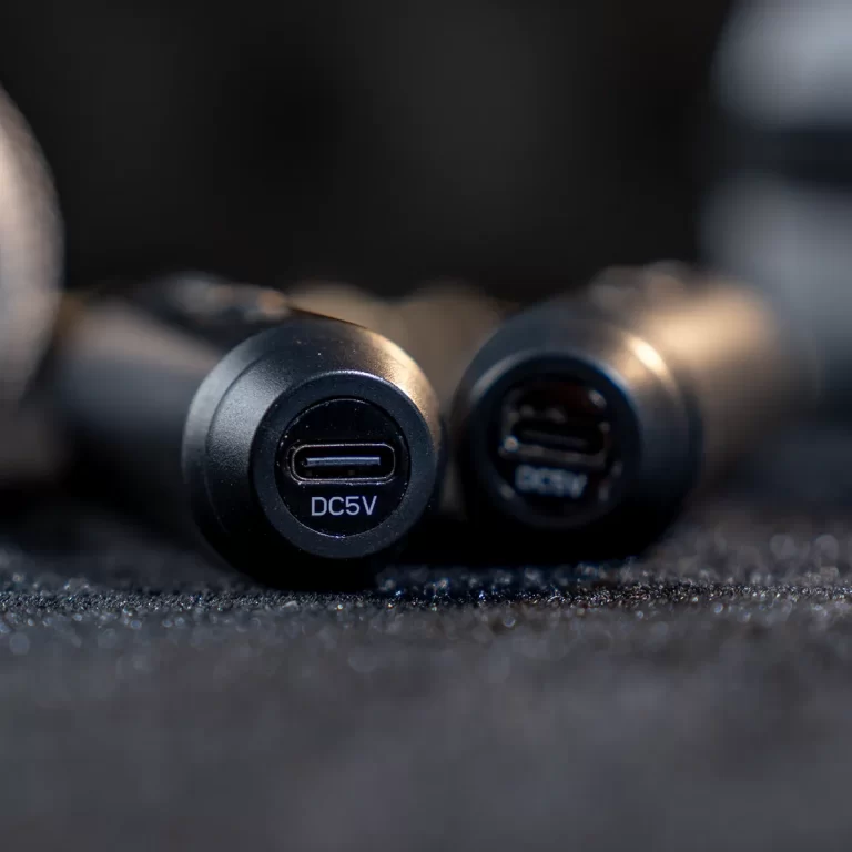 Close-up of two USB-C car charger ports with a DC5V label, resting on a dark textured surface. ขายราคาพิเศษ
