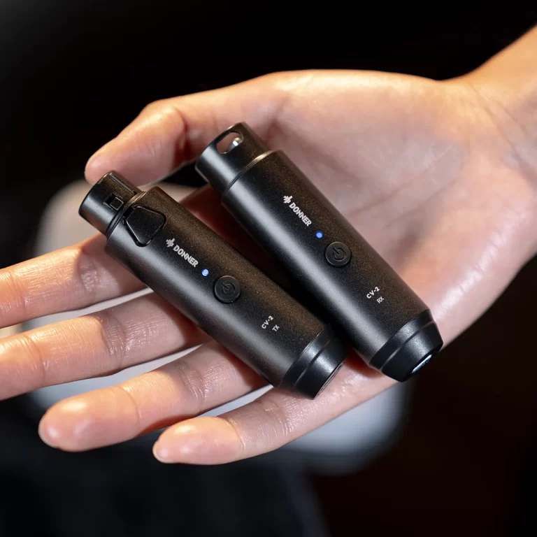 Two black Donner vape batteries held in a hand, showing blue indicator lights and power buttons. ขายราคาพิเศษ