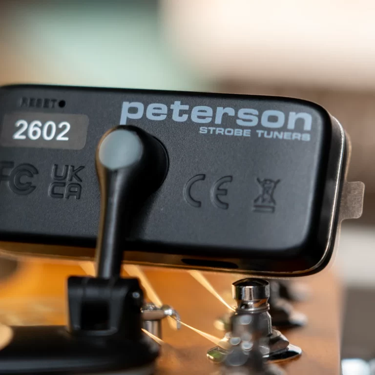 Close-up of a Peterson Strobe Tuners device with the brand name visible on a dark panel. ขายราคาพิเศษ