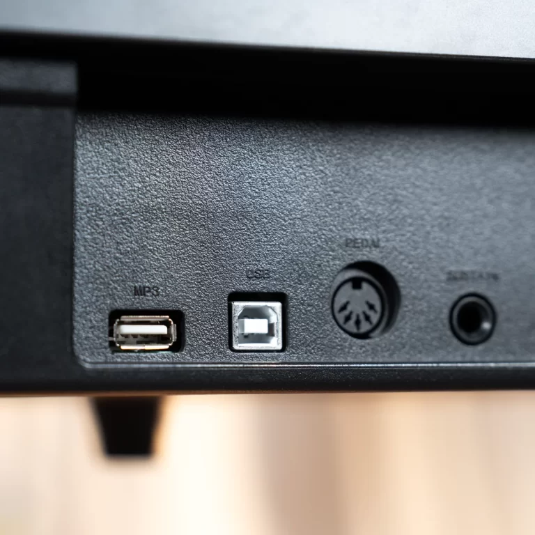 Close-up of a device's rear panel showing a USB port, a square Ethernet-style port, a round PS/2–style connector, and a small circular audio/port nearby. ขายราคาพิเศษ