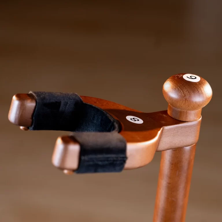 Close-up of a wooden tool handle with a black fabric strap and a small numbered peg marked '8' on the surface. ขายราคาพิเศษ