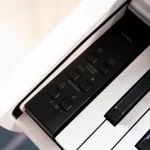 Close-up of a Kawai digital piano control panel with buttons labeled Concert Magic and Recorder beside white keys. ขายราคาพิเศษ