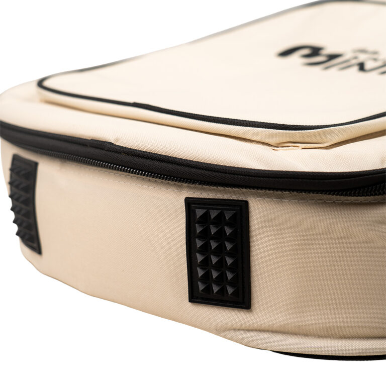 Close-up of a beige fabric bag showing a black zipper and a textured black square patch on the side. ขายราคาพิเศษ