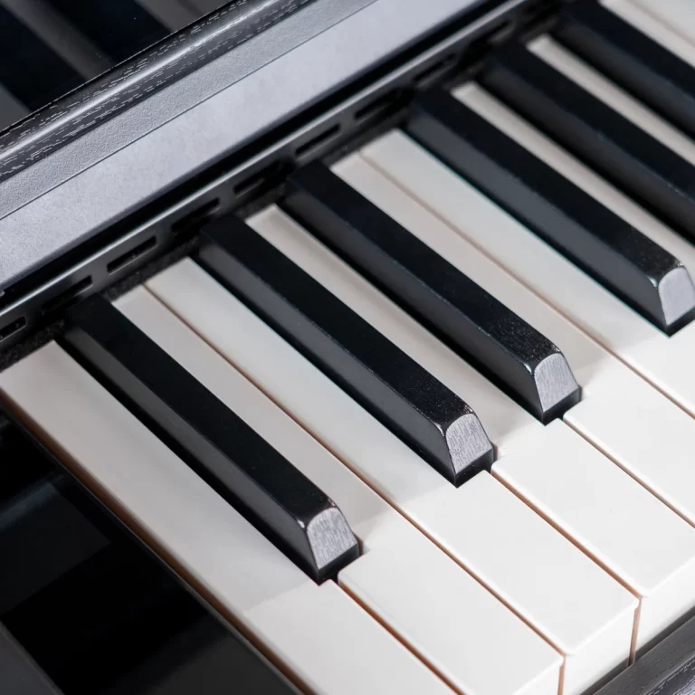 Close-up of black and white piano keys viewed from above, showing texture on the keys and the keyboard edge. ขายราคาพิเศษ