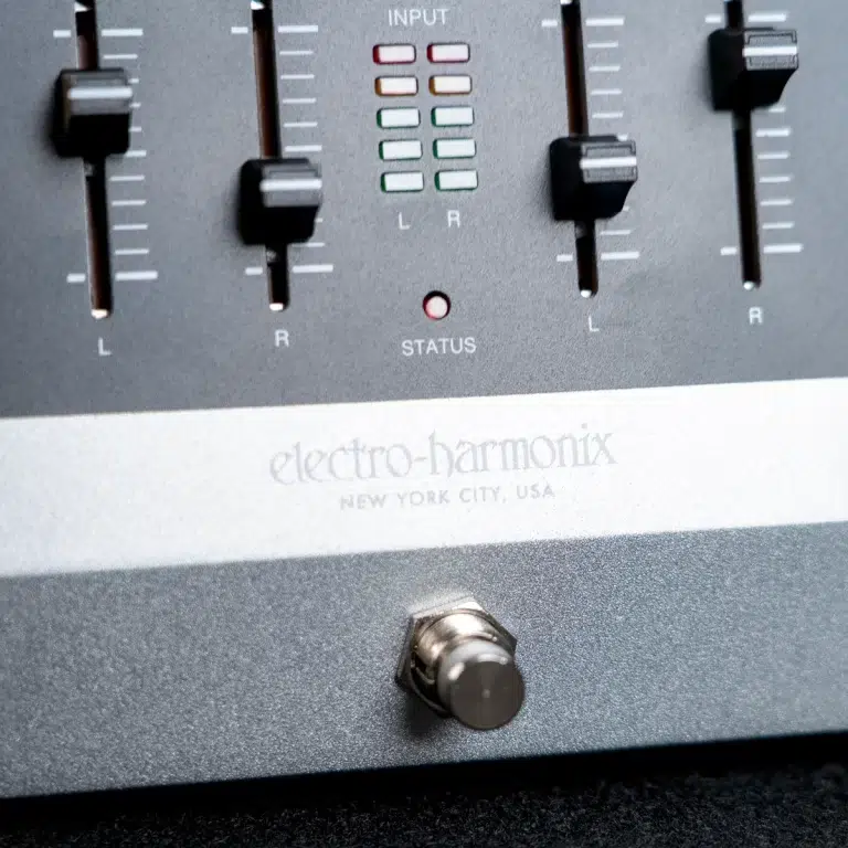 Close-up of an Electro-Harmonix mixer panel with L/R sliders, status LED, and a footswitch below. ขายราคาพิเศษ