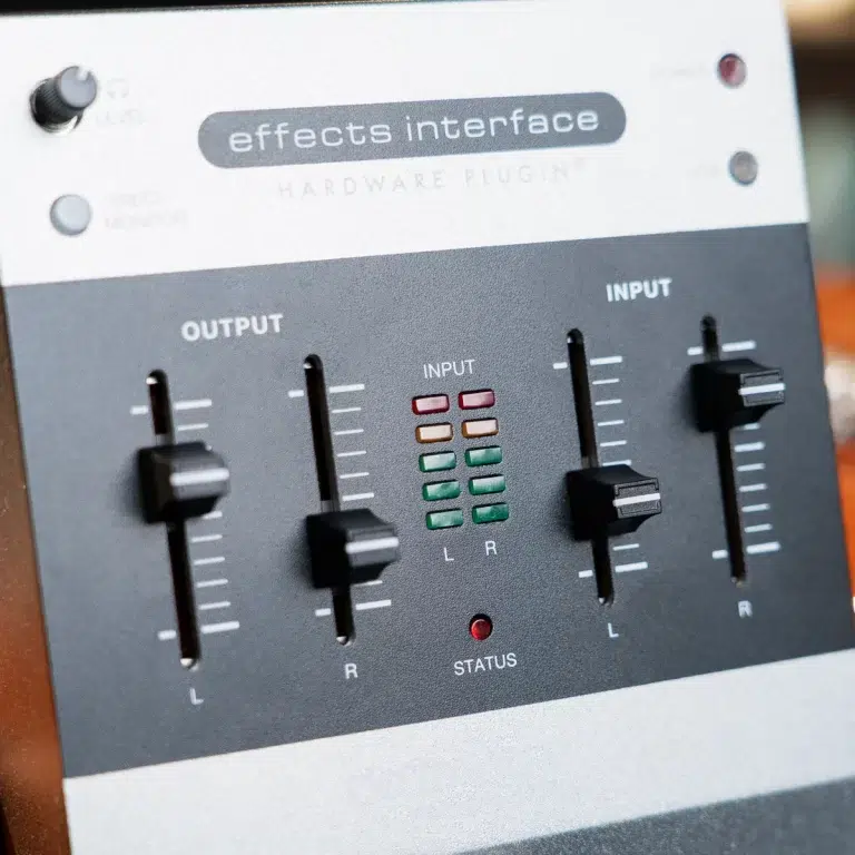 Front panel of a hardware audio effects interface with left/right input/output sliders, LED level meters, and a red status light ขายราคาพิเศษ