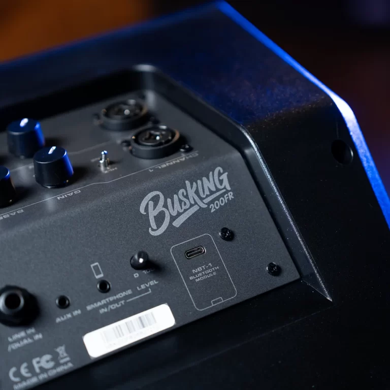 Close-up of a black speaker's rear panel with control knobs, ports, and a USB-C module; branding reads 'Busking 200FR'. ขายราคาพิเศษ