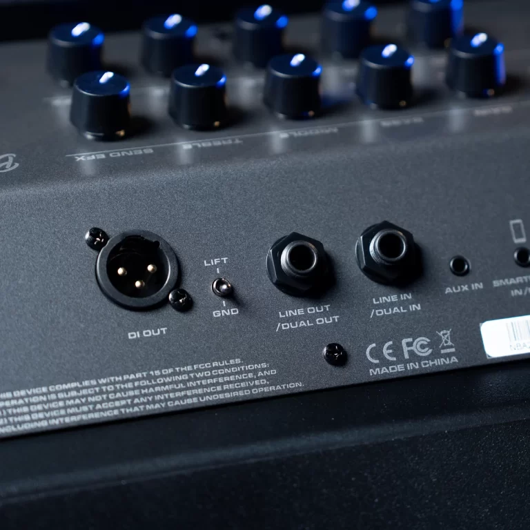 Back panel of an audio mixer with DI OUT, line in/dual in, line out/dual out connectors, a lift switch labeled GND, and several input knobs visible in the background. ขายราคาพิเศษ