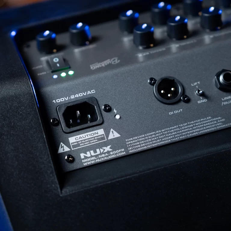 Back panel of an audio mixer showing a 100V-240VAC IEC power inlet, caution label, XLR DI out, and lift/ground switch with blue control knobs. ขายราคาพิเศษ