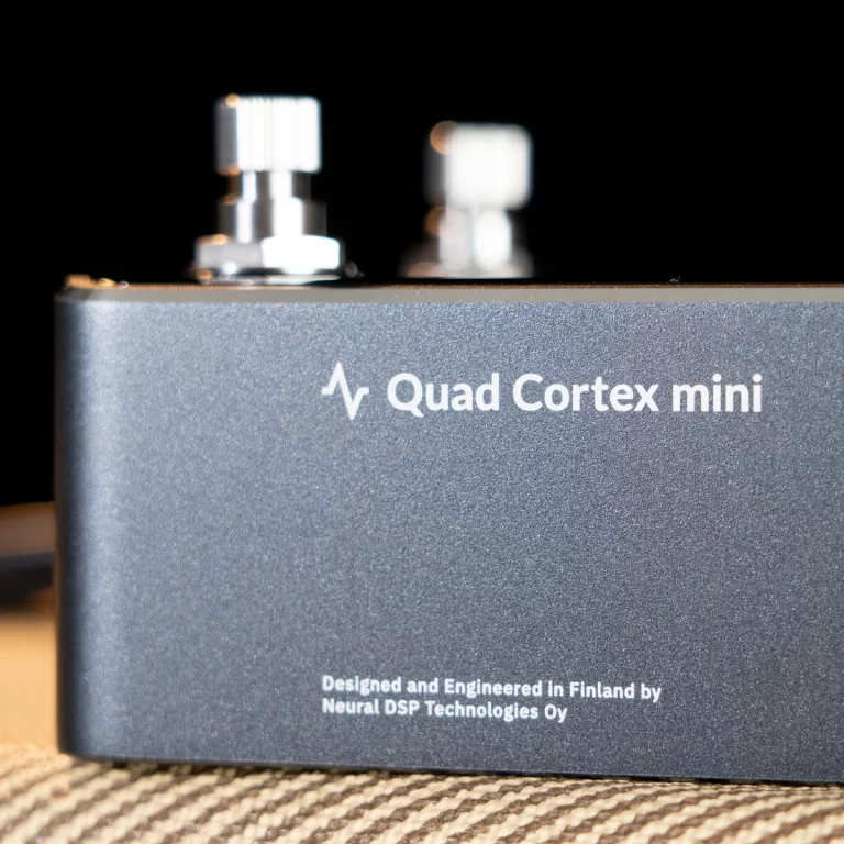 Front view of a Quad Cortex mini audio processor with the model name visible on a dark metal casing. ขายราคาพิเศษ