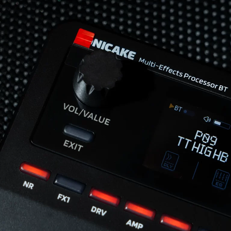 Close-up of a NICAKE Multi-Effects Processor BT pedal with a large black control knob and red tab on top left, showing VOL/VALUE and EXIT labels. ขายราคาพิเศษ