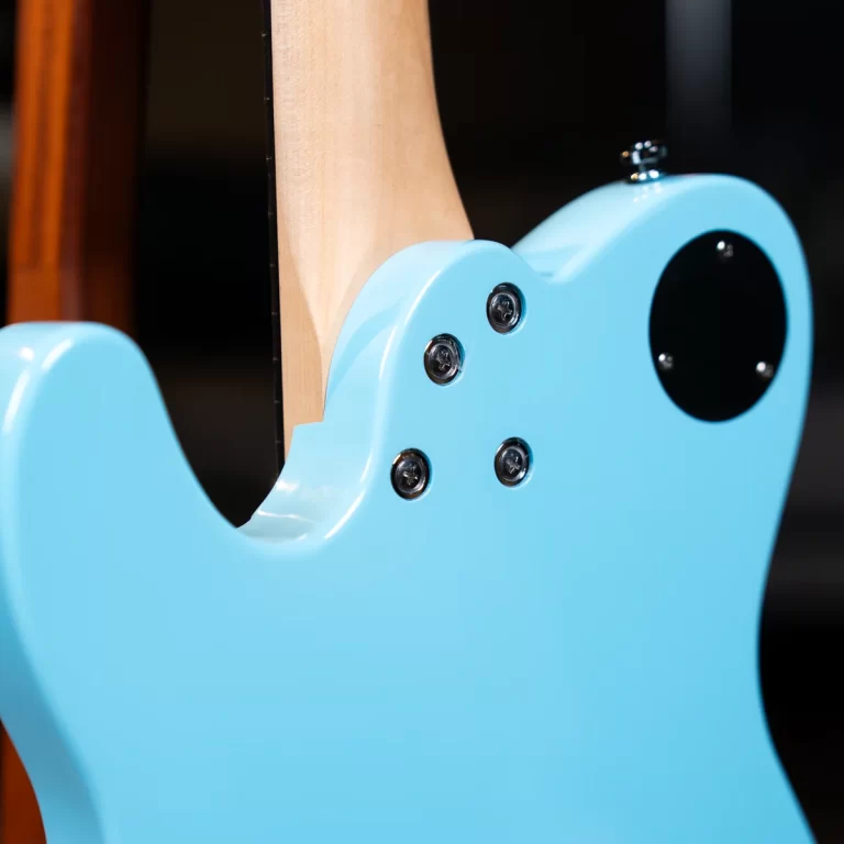 Close-up of a light blue electric guitar body with neck joint and screws visible on a dark background ขายราคาพิเศษ