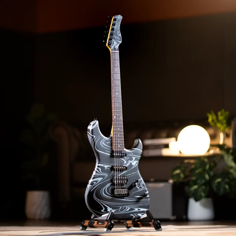 Electric guitar with a gray marble pattern on a stand in a dim room, warm ambient light behind it. ขายราคาพิเศษ