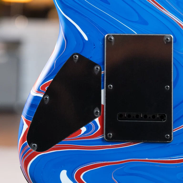 Close-up of a blue electric guitar body with black cover plates and red-white trim detailing. ขายราคาพิเศษ