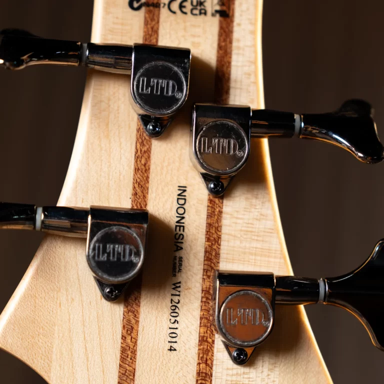 Close-up of a guitar headstock with four chrome LTD tuners and 'INDONESIA' etched on the neck, showing wood grain detail and strings trimming at the edge. ขายราคาพิเศษ