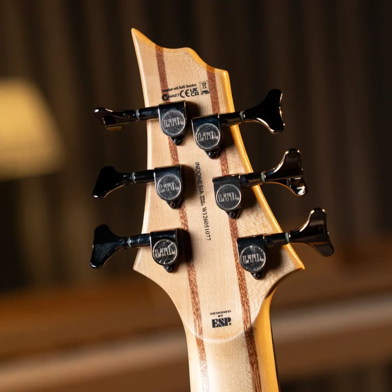 Back of a light-wood guitar headstock with six black tuners and decorative wood stripes. ขายราคาพิเศษ
