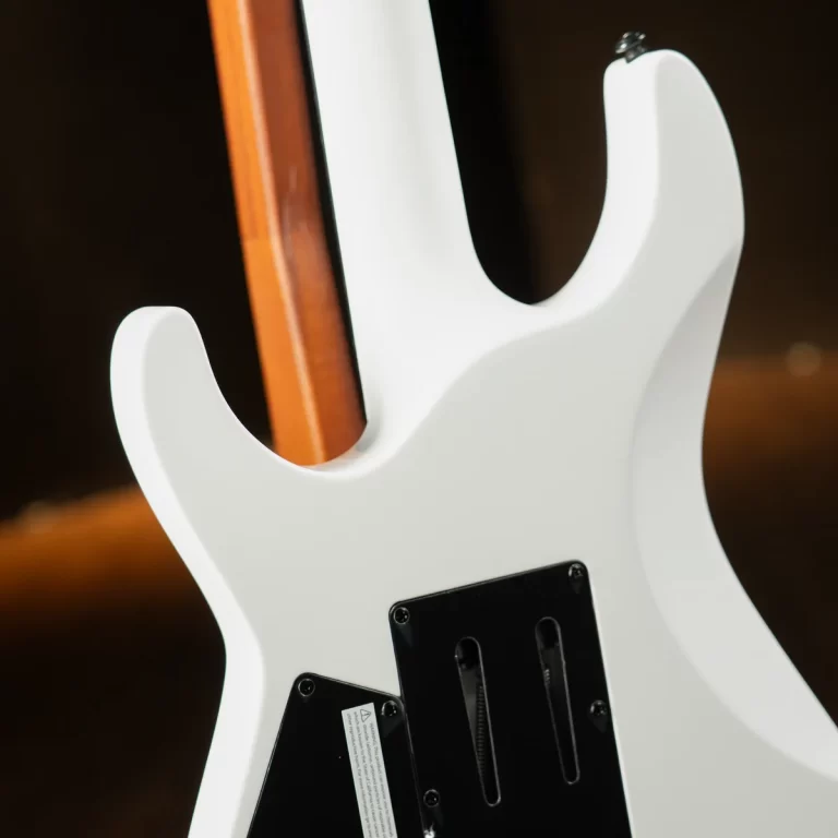 Rear view of a white electric guitar showing a neck-through construction and black control cavity covers ขายราคาพิเศษ