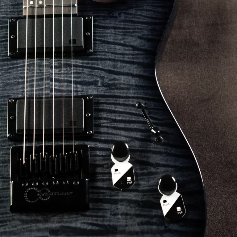 Close-up of a blue quilted-electric guitar body with two humbucker pickups, a black bridge, and control knobs with 'Push'/'Pull' tags visible on the right side. ขายราคาพิเศษ