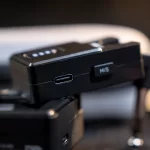 Close-up of a black electronic control unit with a USB-C port and a small switch labeled M/S on a camera rig. ขายราคาพิเศษ