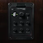 Acoustic guitar preamp panel mounted on wood, showing a lit 'E' note indicator, volume knob, and bass/mid/treble controls labeled on the faceplate. ขายราคาพิเศษ