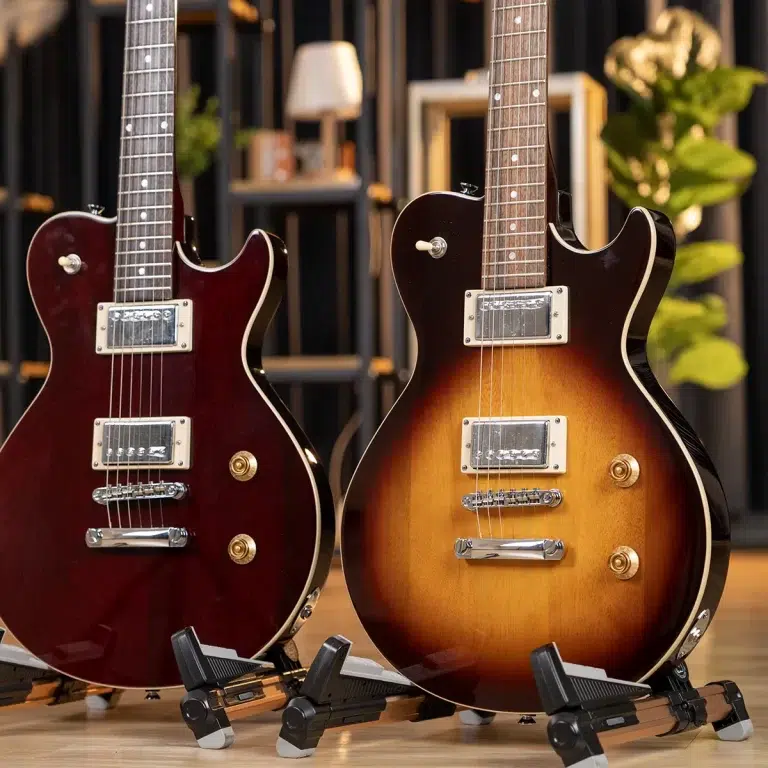 Two electric guitars on stands in a showroom, one burgundy and one sunburst finish with chrome hardware and knobs visible. This setup highlights their glossy bodies and pickups. ขายราคาพิเศษ