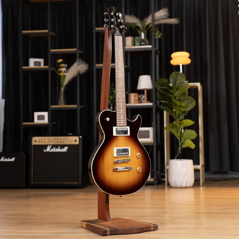 Sunburst electric guitar on a wooden stand in a showroom with amplifiers in the background. ขายราคาพิเศษ
