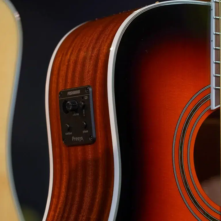 Close-up of an acoustic guitar body showing a Fishman preamp control panel mounted on the side near the soundhole edge. ขายราคาพิเศษ