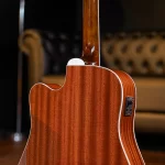 Close-up of a polished wooden back and neck of an acoustic guitar, showing the curved body and white binding near the heel and neck joint. ขายราคาพิเศษ