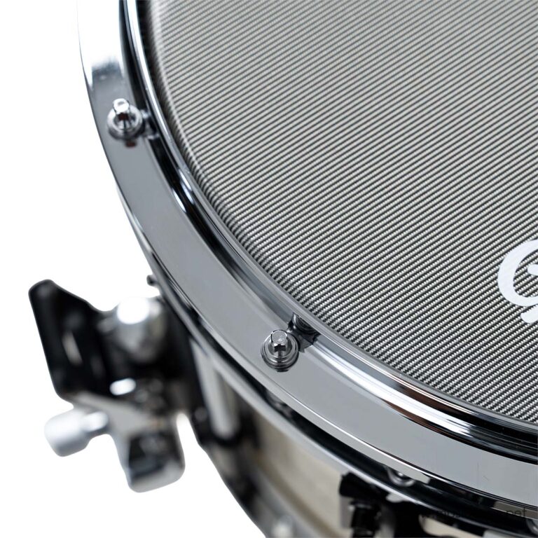 Close-up of a drum shell with a carbon-fiber textured head and chrome hardware, showing tension rods and rim ขายราคาพิเศษ